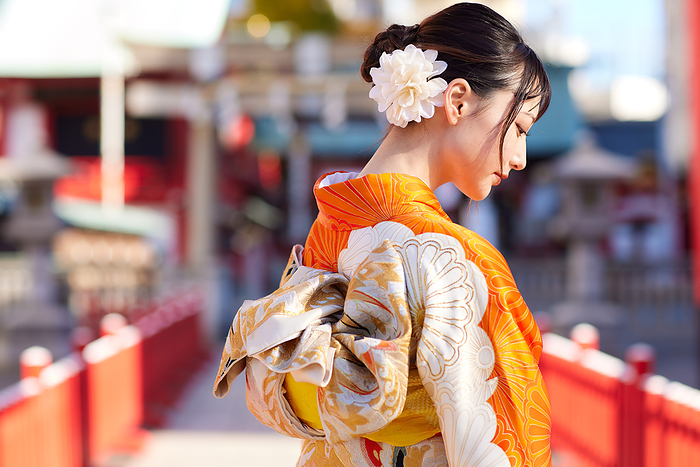 Japanese woman in furisode kimono with her eyes down