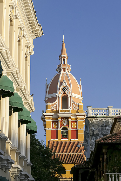 Close up view to the clock tower of the cathedral and white House facade with blue sky, Cartagena, C Close up view to the clock tower of the cathedral and white House facade with blue sky, Cartagena, C, by Zoonar Uwe Bergwitz