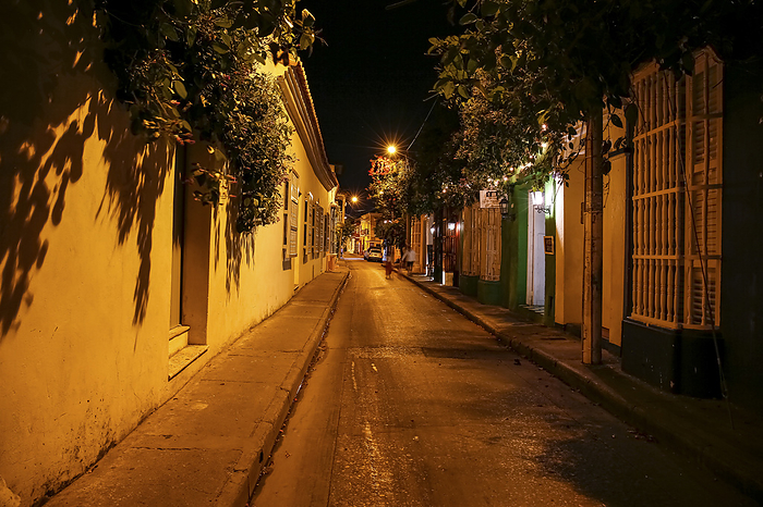 Iluminated empty street at night with colonial buildings in Cartagena, Unesco World Heritage Iluminated empty street at night with colonial buildings in Cartagena, Unesco World Heritage, by Zoonar Uwe Bergwitz