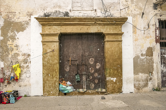 Old church door with colorful selling goods of a street vendor, Cartagena, Colombia Old church door with colorful selling goods of a street vendor, Cartagena, Colombia, by Zoonar Uwe Bergwitz