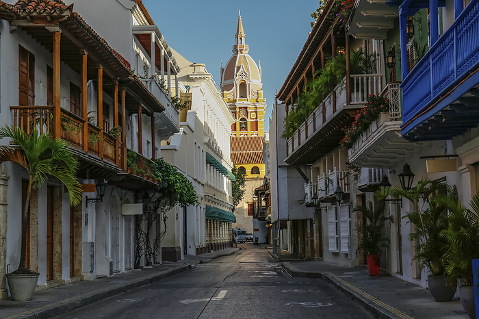 View to the clock tower of Cartagena cathedral with blue sky through a narrow street in shadow, Cart View to the clock tower of Cartagena cathedral with blue sky through a narrow street in shadow, Cart, by Zoonar Uwe Bergwitz