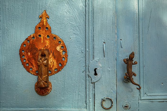 Close up of an old bright blue colored door with ornamental metall door knocker and handle, Barichar Close up of an old bright blue colored door with ornamental metall door knocker and handle, Barichar, by Zoonar Uwe Bergwitz