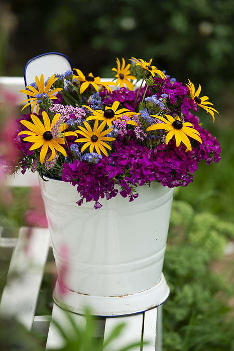 Colorful summer flowers in a bucket Colorful summer flowers in a bucket, by Zoonar Judith Kiener