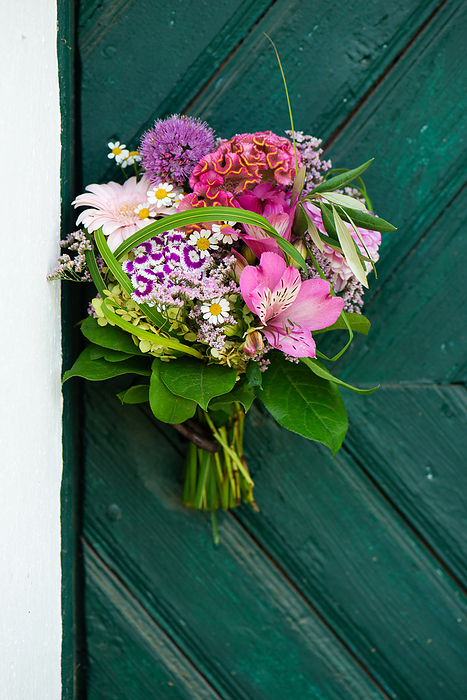Colorful flower bouquet on a wooden door Colorful flower bouquet on a wooden door, by Zoonar Judith Kiener