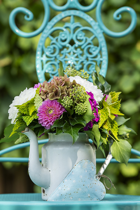 Romantic flower bouquet on a garden chair Romantic flower bouquet on a garden chair, by Zoonar Judith Kiener