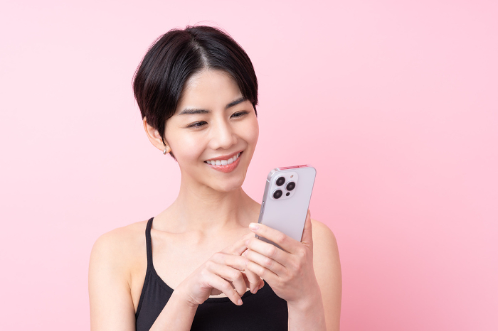 Young Japanese woman holding a cell phone (People)