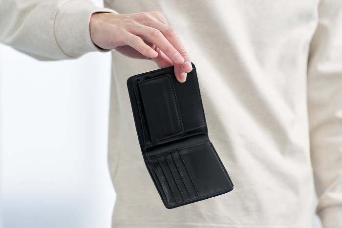 Japanese man holding wallet with no money in it (People)