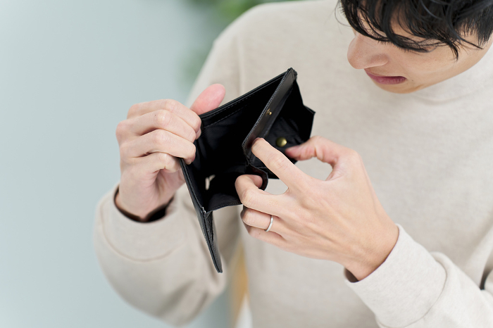 Japanese man holding wallet with no money in it (People)
