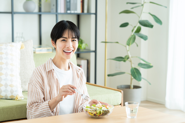 Young Japanese woman eating salad (People)