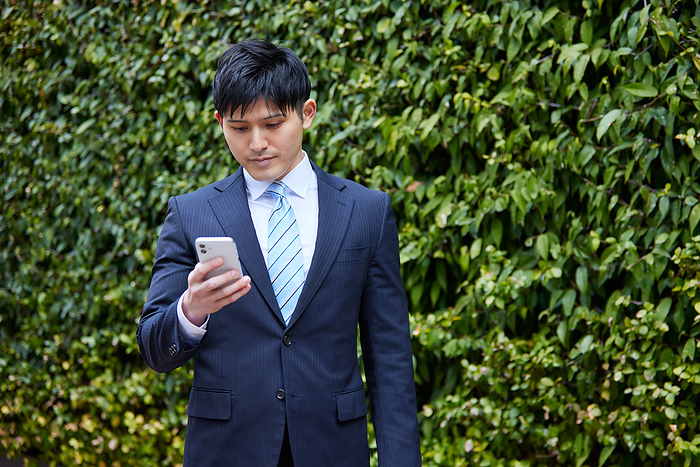 Japanese man operating a smartphone