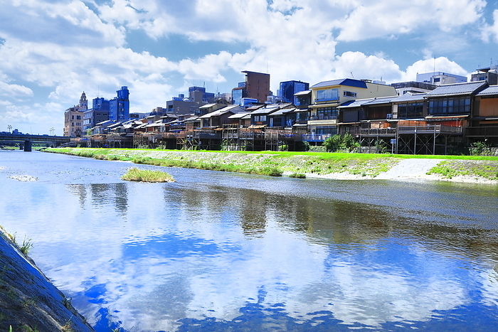 The Kamo River and the town along the Kamo River in Kyoto, Kyoto, Japan, with summer clouds spreading out. Shooting downstream between the Shijo and Sanjo Ohashi bridges