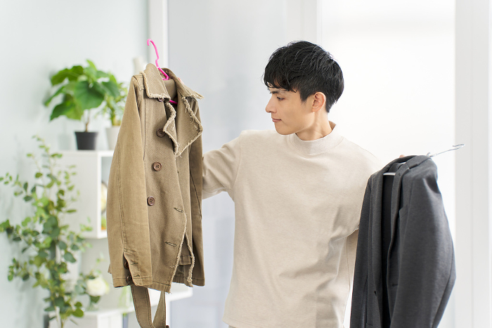 Japanese man arranging clothes (People)