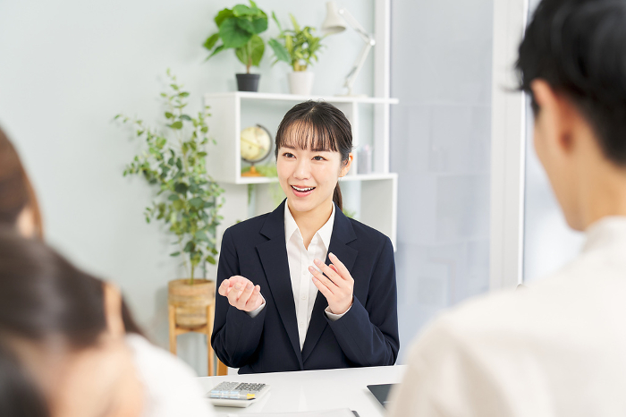 Japanese businesswoman giving information on insurance (Female / People)
