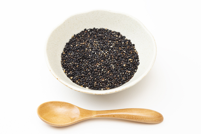 Black sesame seeds on white background
