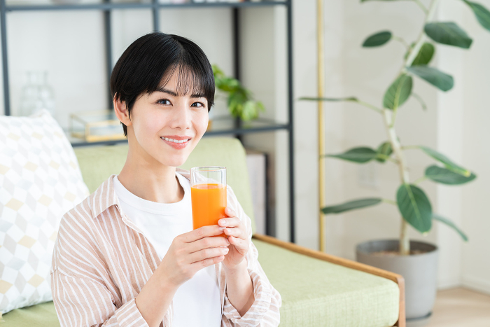 Young Japanese woman drinking vegetable juice (People)