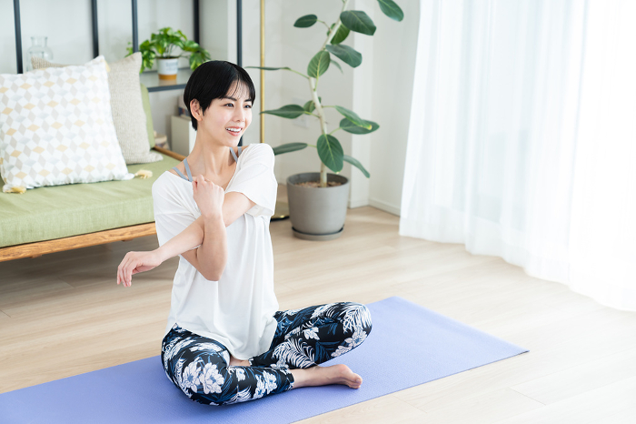 Young Japanese woman practicing yoga at home (People)