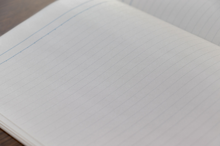 White notebook with horizontal ruled lines