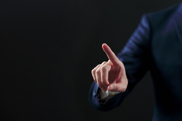 Japanese businessman pointing with black background (People)