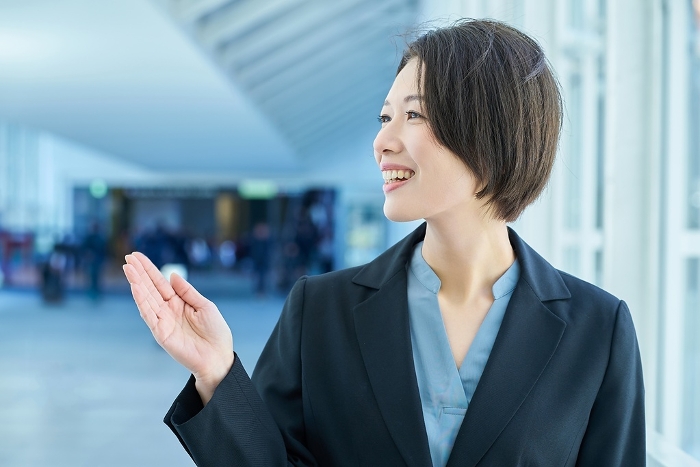 A Japanese woman in a suit posing as a guide (People)