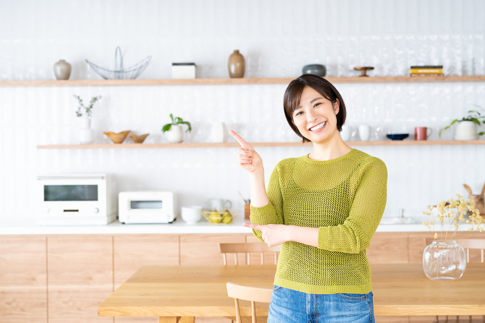 Young Japanese woman standing in the kitchen/dining room (People)