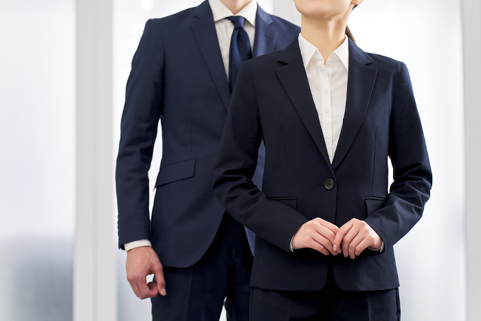 Japanese businesspersons, male and female, wearing suits (People)