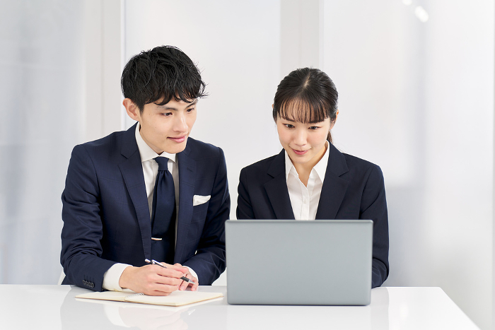 Japanese businesspeople training on how to use a computer (People)