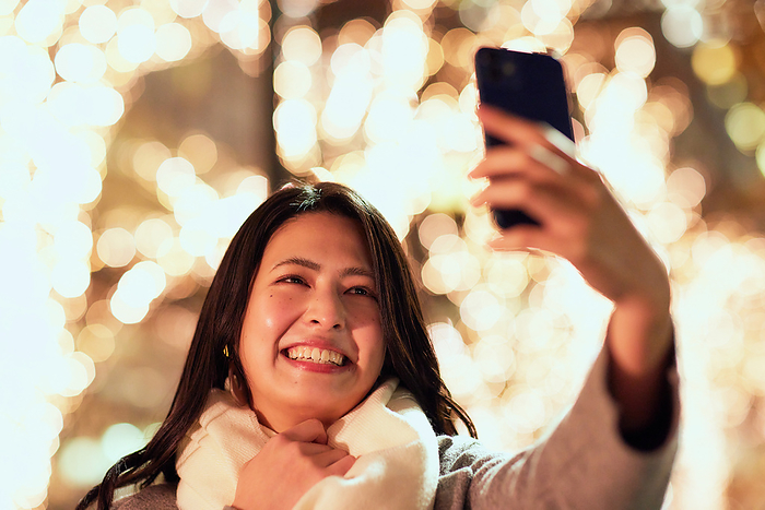 Japanese woman taking a selfie with her smartphone