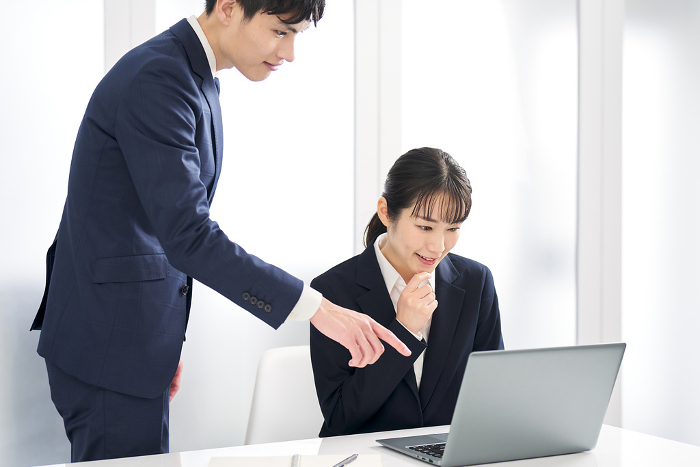 Japanese businesswoman being told she made a mistake at work.