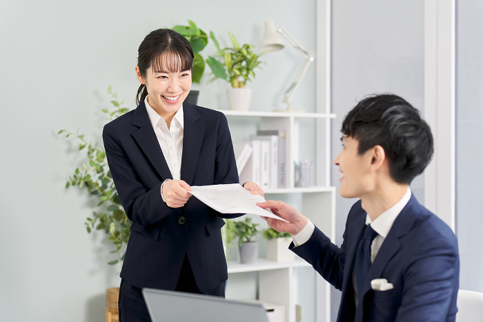 Japanese businessperson checking a subordinate's work (People)