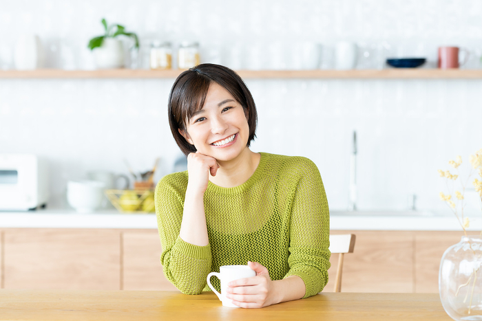 Young Japanese woman relaxing in the dining room (People)