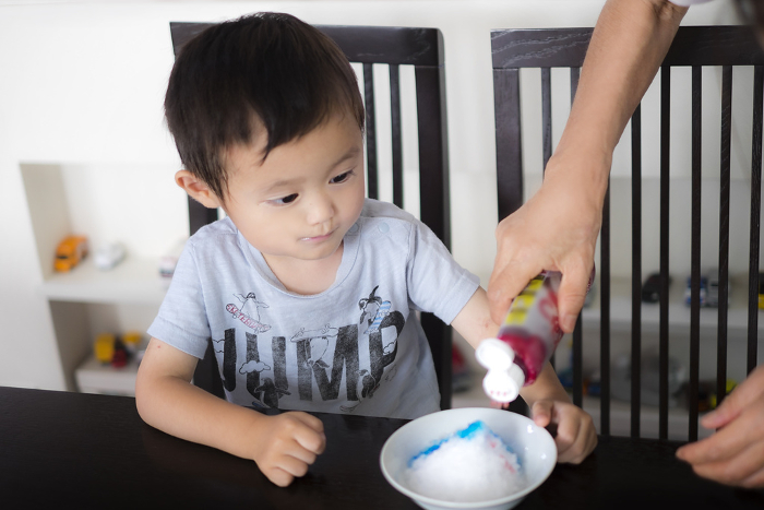 A 3-year-old boy having shaved ice made