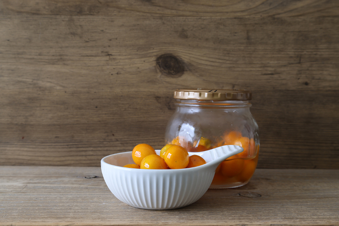 Kumquat in glass jar with honey