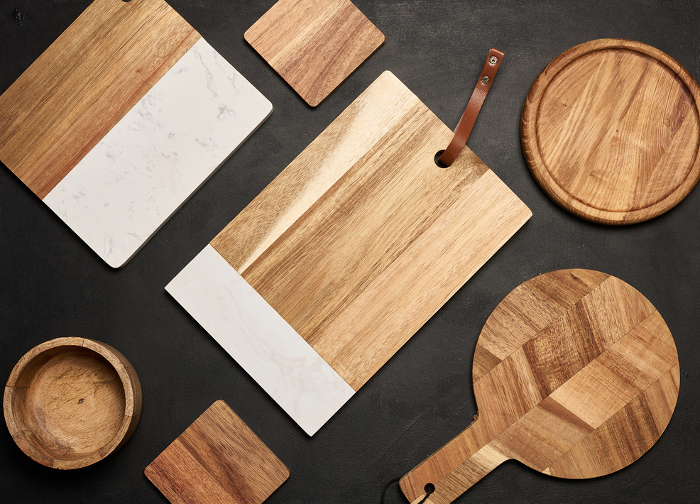 Various wooden cutting boards on a black table, top view Various wooden cutting boards on a black table, top view