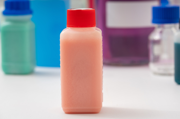 Plastic bottle with red liquid, conceptual image Plastic bottle with red liquid. Samples of food colouring in a food quality laboratory., by Wladimir Bulgar SCIENCE PHOTO LIBRARY
