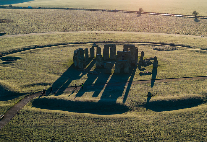 Aerial view of Stonehenge in morning light, Wiltshire, UK Aerial view of Stonehenge in Wiltshire, UK, with the low sun accentuating the circular henge and standing stones with long shadows. Stonehenge is one of the most famous prehistoric monuments in the world, it consists of a ring of standing stones, each around 4 metres high, 2.1 metres wide, and weighing around 23 tonnes. The construction of Stonehenge is believed to have started around 3000 BCE. Although it s exact purpose remains a topic of debate, it is thought to have been used as a burial ground, an astronomical observatory, and a site for religious rituals and ceremonies. Today, Stonehenge is a UNESCO World Heritage Site., by LIGHTNING STRIKE MEDIA SCIENCE PHOTO LIBRARY