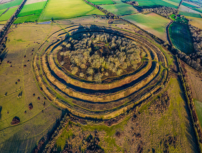 Aerial view of Badbury Rings hill fort, Dorset, UK Aerial view of Badbury Rings hill fort in Dorset, UK. The fort was constructed around 800 BC and was occupied until the Roman invasion of Britain in the 1st century AD. The fort s primary purpose was to provide defensive fortifications to the inhabitants, and it consists of three circular ramparts. Excavations in the area have revealed evidence of human activity within the fort, including the remains of buildings and pottery., by LIGHTNING STRIKE MEDIA SCIENCE PHOTO LIBRARY