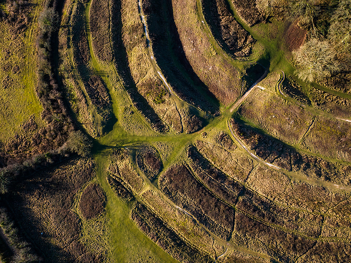 Aerial view of Badbury Rings hill fort, Dorset, UK Aerial view of the southern facing ditches and ramparts at Badbury Rings hill fort, Dorset, UK. The fort was constructed around 800 BC and was most likely inhabited by the Durotriges tribe until the Roman invasion of Britain in the 1st century AD. The fort s primary purpose was to provide defensive fortifications to the inhabitants, and it consists of three circular ramparts. Excavations in the area have revealed evidence of human activity within the fort, including the remains of buildings and pottery., by LIGHTNING STRIKE MEDIA SCIENCE PHOTO LIBRARY