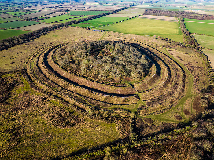 Aerial view of Badbury Rings hill fort, Dorset, UK Aerial view of Badbury Rings hill fort in Dorset, UK. The fort was constructed around 800 BC and was most likely inhabited by the Durotriges tribe until the Roman invasion of Britain in the 1st century AD. The fort s primary purpose was to provide defensive fortifications to the inhabitants, and it consists of three circular ramparts. Excavations in the area have revealed evidence of human activity within the fort, including the remains of buildings and pottery., by LIGHTNING STRIKE MEDIA SCIENCE PHOTO LIBRARY