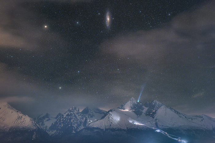 Comet 12P Pons Brooks and Andromeda galaxy above High Tatras, composite image Composite image of comet 12P Pons rooks  blue, bottom right  and the Andromeda galaxy  top centre  photographed on 4 March 2024 above the High Tatra Mountains, Slovakia. Pons Brooks is only visible for a short time every 71.2 years, which is the length of time it takes to orbit the Sun. It was first discovered in 1812 by Louis Pons, and is estimated to be around 30 km in diameter. Comets are collections of dust and ice that orbit the Sun. As they near the Sun and are warmed they release gas  outgassing  that forms the tail., by PETR HORALEK SCIENCE PHOTO LIBRARY