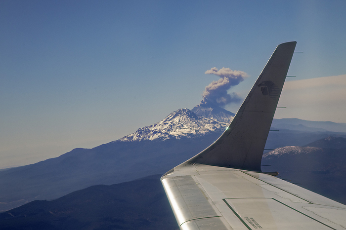 Passenger jet flying past erupting volcano AeroMexico passenger jet flying past the erupting Popocatepetl volcano near Mexico city, Mexico., by JIM WEST SCIENCE PHOTO LIBRARY