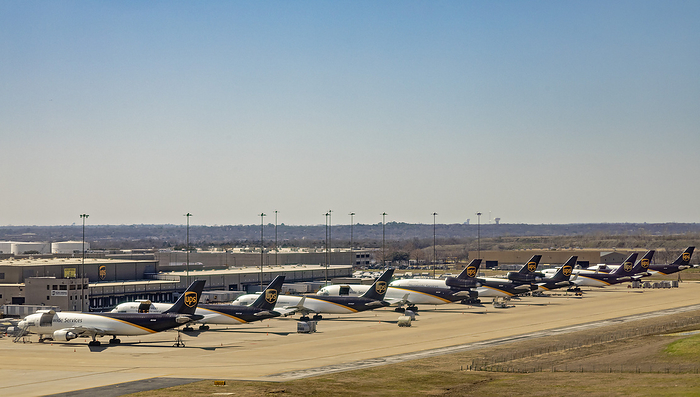 Cargo jets parked at airport United Parcel Service  UPS  cargo jets parked at Dallas Fort Worth International Airport, Texas, USA., by JIM WEST SCIENCE PHOTO LIBRARY