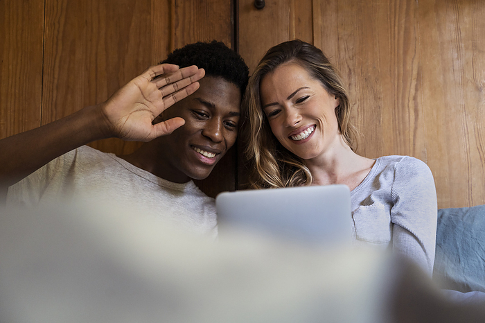 Young adult couple having a video call on digital tablet