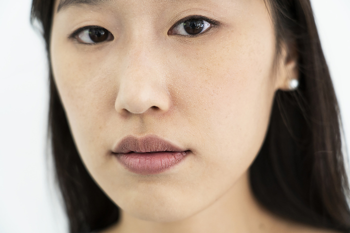 Close up portrait of young adult woman looking at the camera