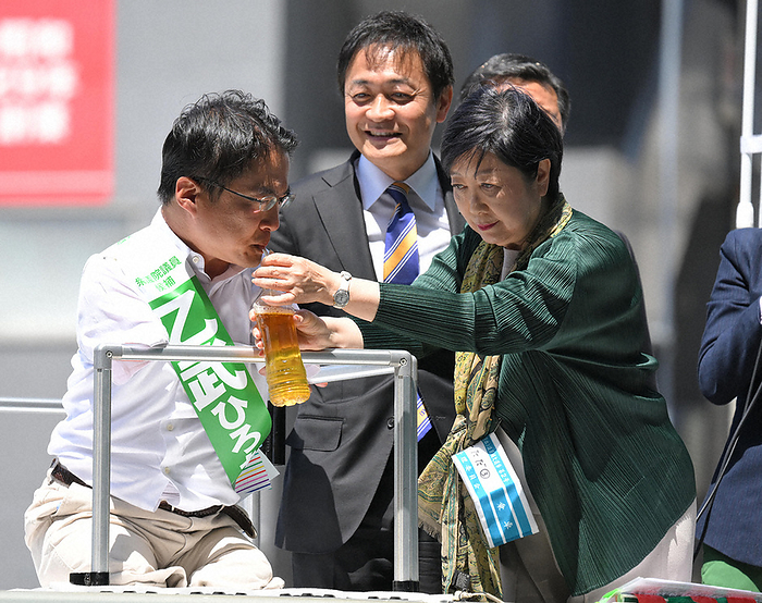 Tokyo 15th House of Representatives by election announced Hirotada Otome  left  hydrates with the help of Tokyo Governor Yuriko Koike  right  after finishing his street speech. At the back center is Yuichiro Tamaki, representative of the Democratic Party of Japan.