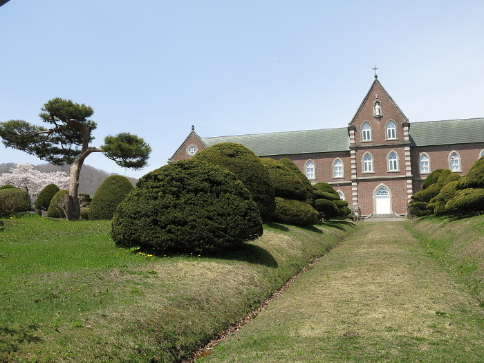 Trappist Monastery (main building) in Hokuto City with cherry blossoms