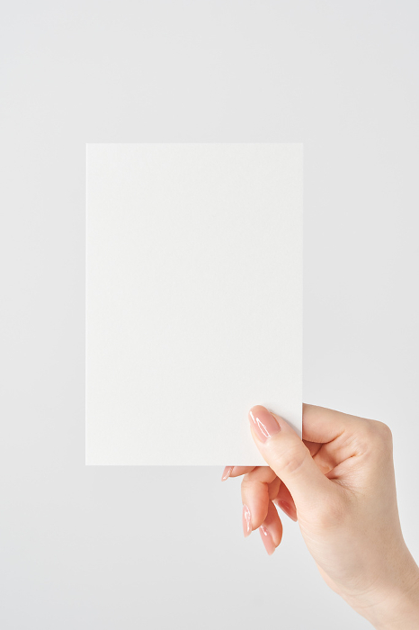 Woman's hand holding white paper
