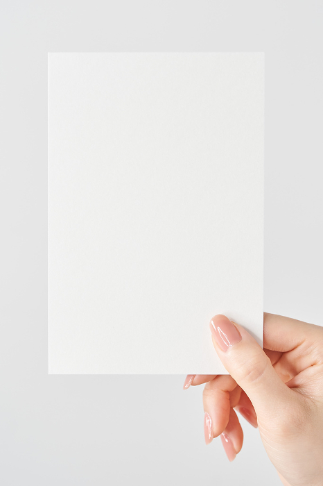Woman's hand holding white paper
