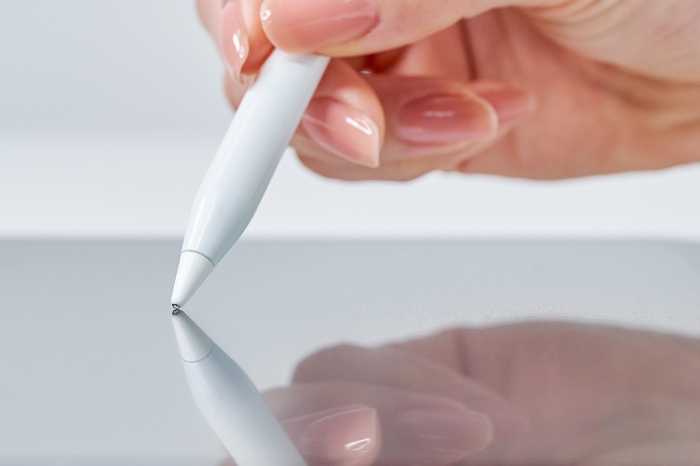 Woman's hand operating stylus pen