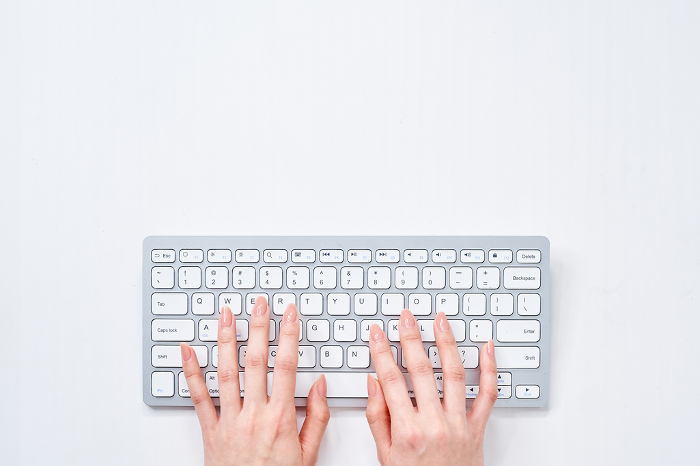 Woman's hand typing on keyboard