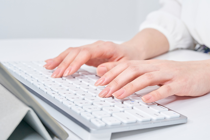 Woman's hand typing on keyboard